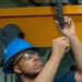 Deck Department Sailor works on bridge crane