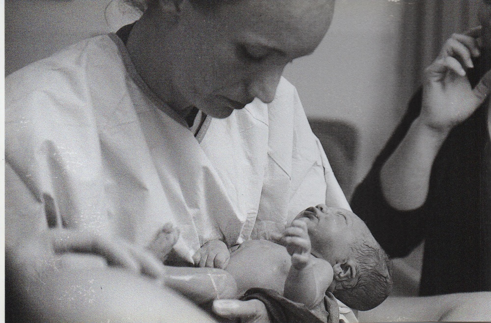 Army Physician Cradles a Newborn