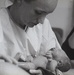 Army Physician Cradles a Newborn