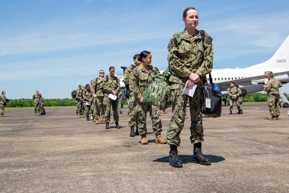 U.S. Navy Sailors wait to be screen on the flightline