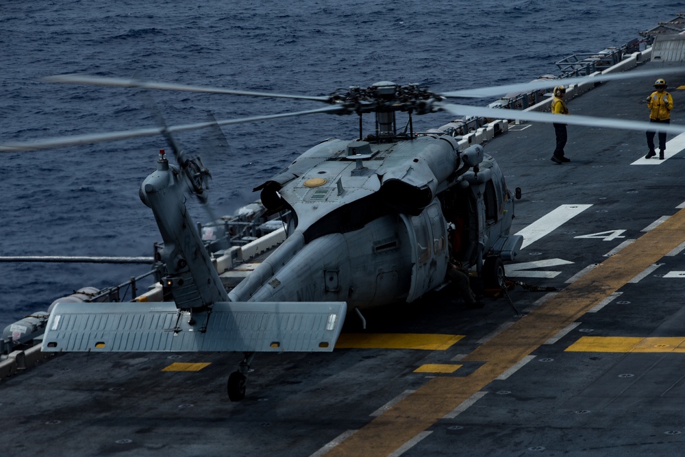 Marines with 31st MEU and Sailors with the USS America conduct flight operations on the America