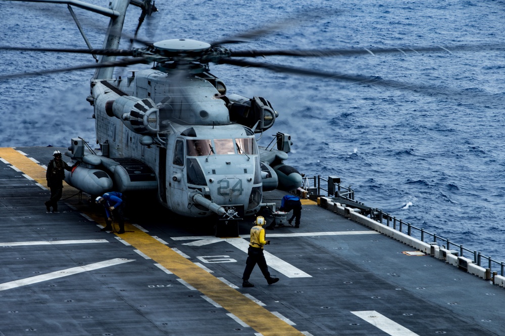 Marines with 31st MEU and Sailors with the USS America conduct flight operations on the America