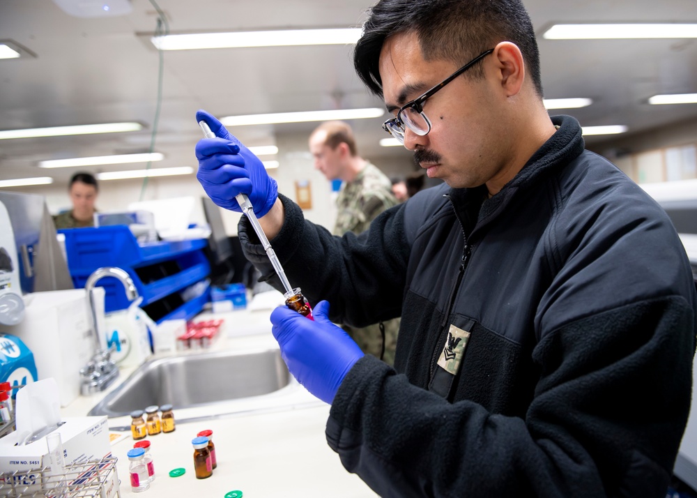 USNS Mercy Sailor Works in Laboratory