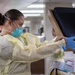 USNS Mercy Sailor Dons Surgical Gloves