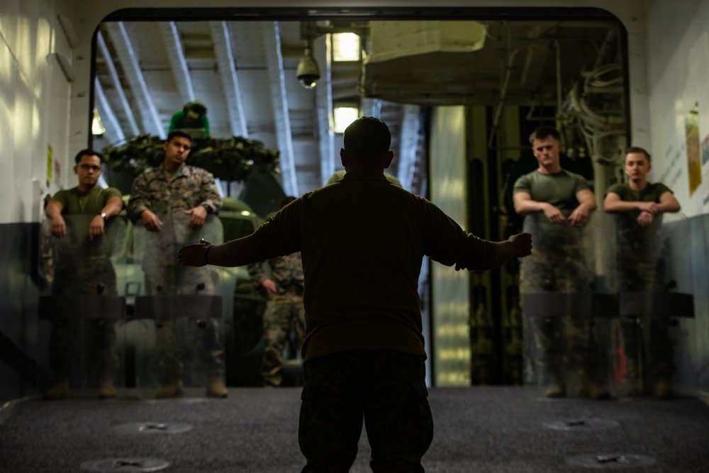 31st MEU Marines practice riot control techniques aboard USS America