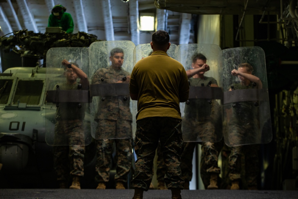 31st MEU Marines practice riot control techniques aboard USS America