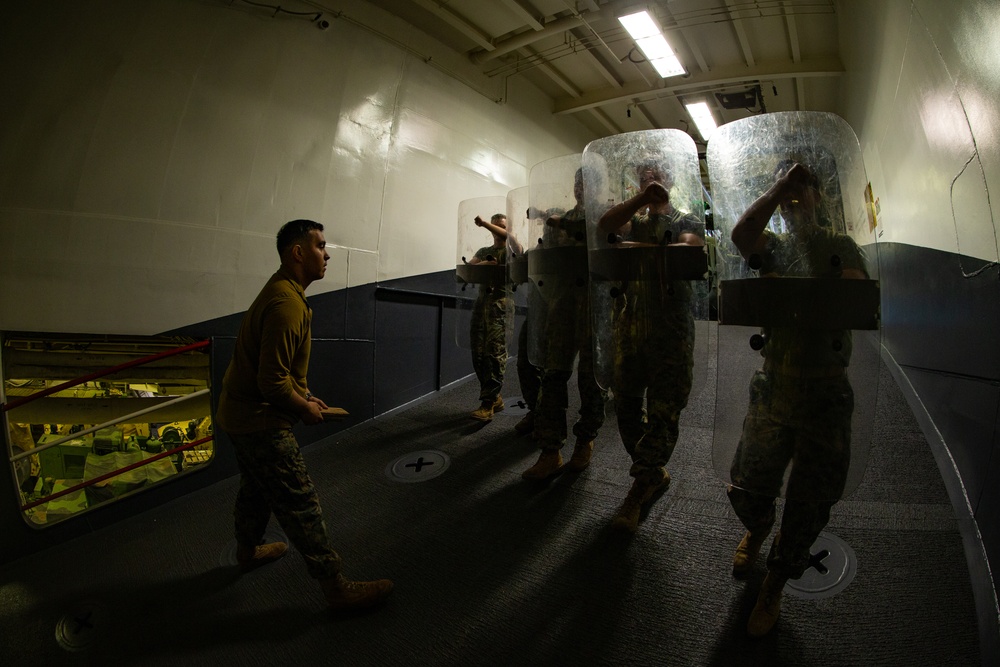 31st MEU Marines practice riot control techniques aboard USS America