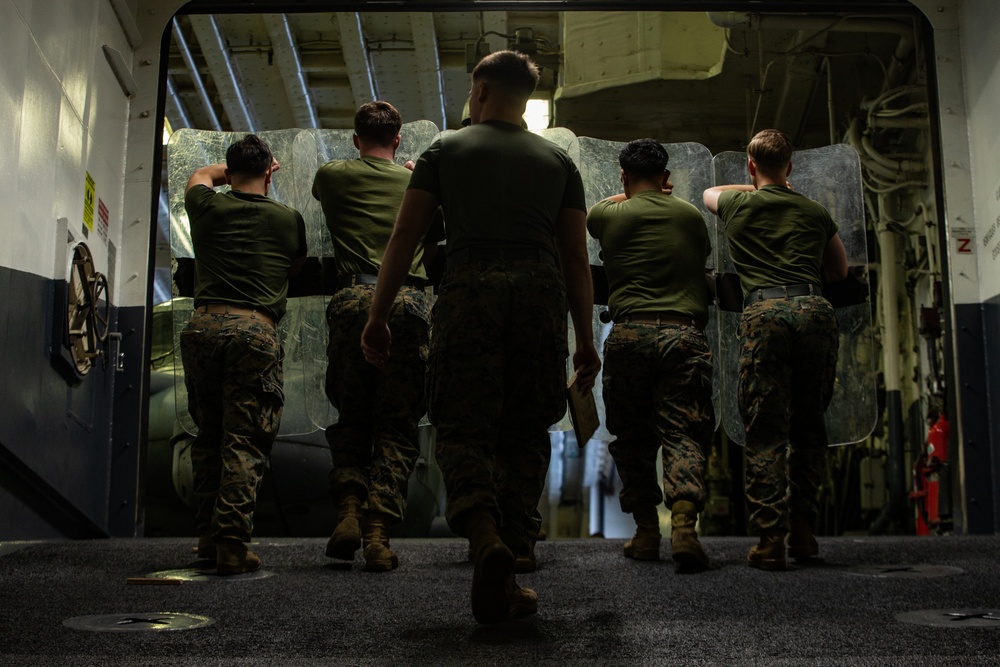 31st MEU Marines practice riot control techniques aboard USS America