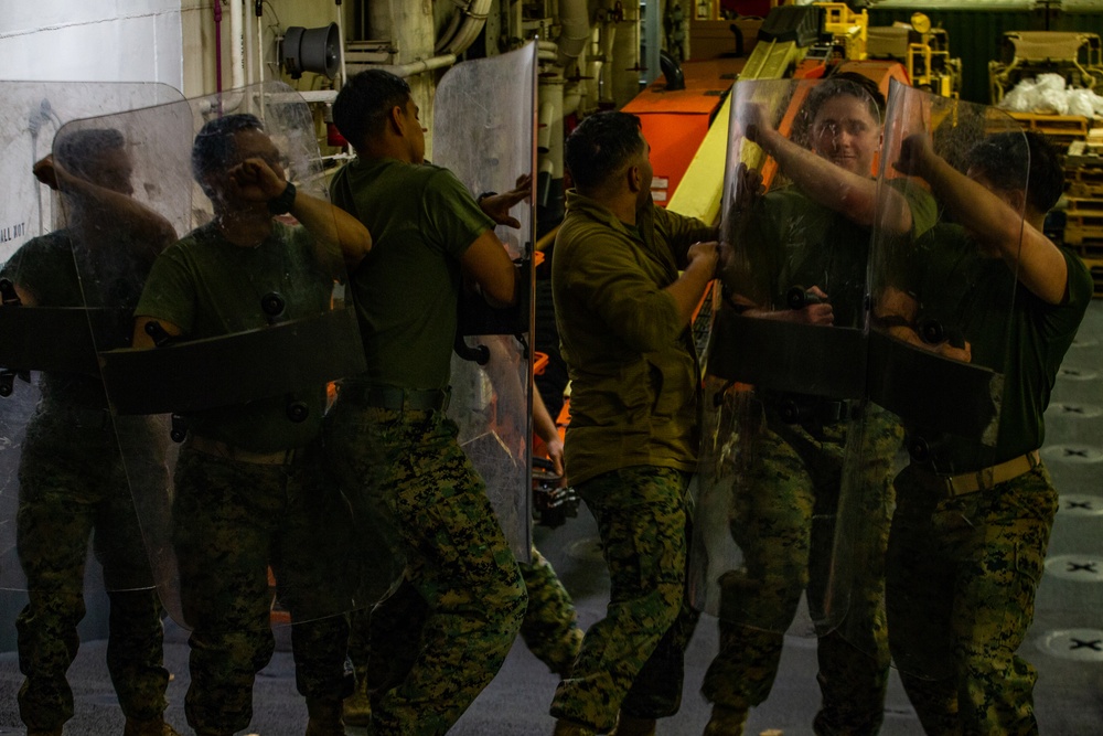 31st MEU Marines practice riot control techniques aboard USS America