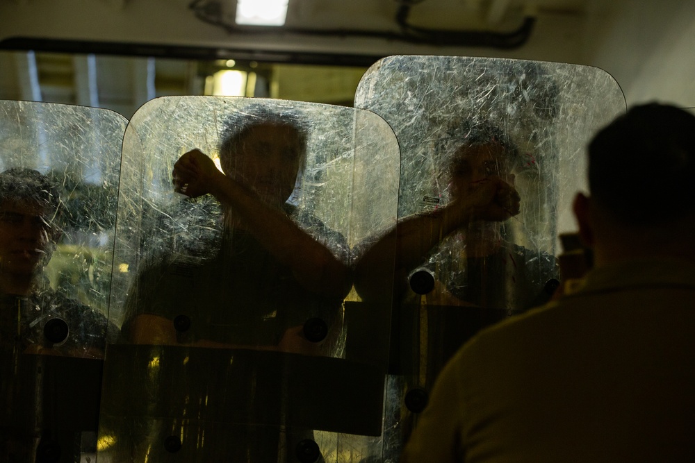 31st MEU Marines practice riot control techniques aboard USS America