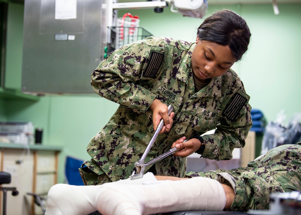 USNS Mercy Sailor Removes a Cast During Training
