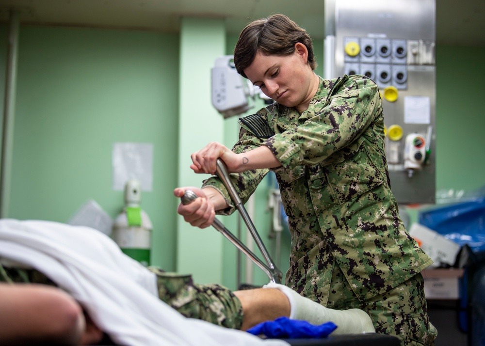 USNS Mercy Sailor Removes a Cast During Training