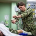 USNS Mercy Sailor Removes a Cast During Training