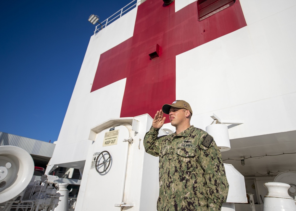 USNS Mercy Sailor Render a Hand Salute