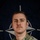 NATO BG-P EIB and ESB awardees A military portrait photograph of a soldier in US Army MultiCam (OCP) camouflage uniform, posed against a NATO flag backdrop. The soldier wears visible unit patches including a Ranger tab and NATO-OTAN eFP Battle Group insignia. The image is an official NATO Enhanced Forward Presence (eFP) promotional portrait.