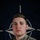 NATO BG-P EIB and ESB awardees A U.S. Army soldier named Giese is photographed in a formal portrait style against a NATO flag backdrop. The soldier is wearing MultiCam (OCP) camouflage uniform with visible U.S. Army and NATO-related patches. The image appears to be an official NATO Enhanced Forward Presence (eFP) Battle Group promotional photograph.