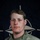 NATO BG-P Soldiers test on EIB and ESB tasks A U.S. Army soldier poses for an official portrait against a NATO flag backdrop. The soldier is wearing OCP (Operational Camouflage Pattern) uniform with visible name tape reading 'ROISON' and 'U.S. ARMY' tape. The image is associated with NATO's enhanced Forward Presence (eFP) Battle Group Poland initiative.