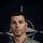 NATO BG-P Soldiers test on EIB and ESB tasks A U.S. Army soldier poses for an official portrait in front of a NATO flag backdrop. The soldier is wearing OCP (Operational Camouflage Pattern) uniform with visible name tape, branch tape, and military badges. The image is part of a NATO eFP (enhanced Forward Presence) Battle Group promotional campaign.