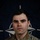 NATO BG-P Soldiers test on EIB and ESB tasks A formal military portrait of a U.S. Army soldier named Titarenko, photographed against a NATO flag backdrop. The soldier is wearing MultiCam (OCP) camouflage uniform with visible rank and branch insignia. This appears to be an official NATO Enhanced Forward Presence (eFP) Battle Group promotional image.