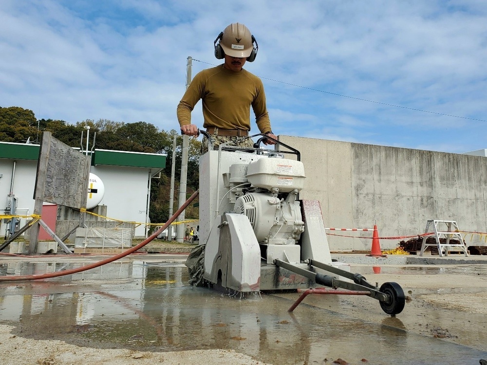 U.S. Navy Seabees with NMCB-5’s Detail Sasebo work on two pre-engineered buildings for NBU-7