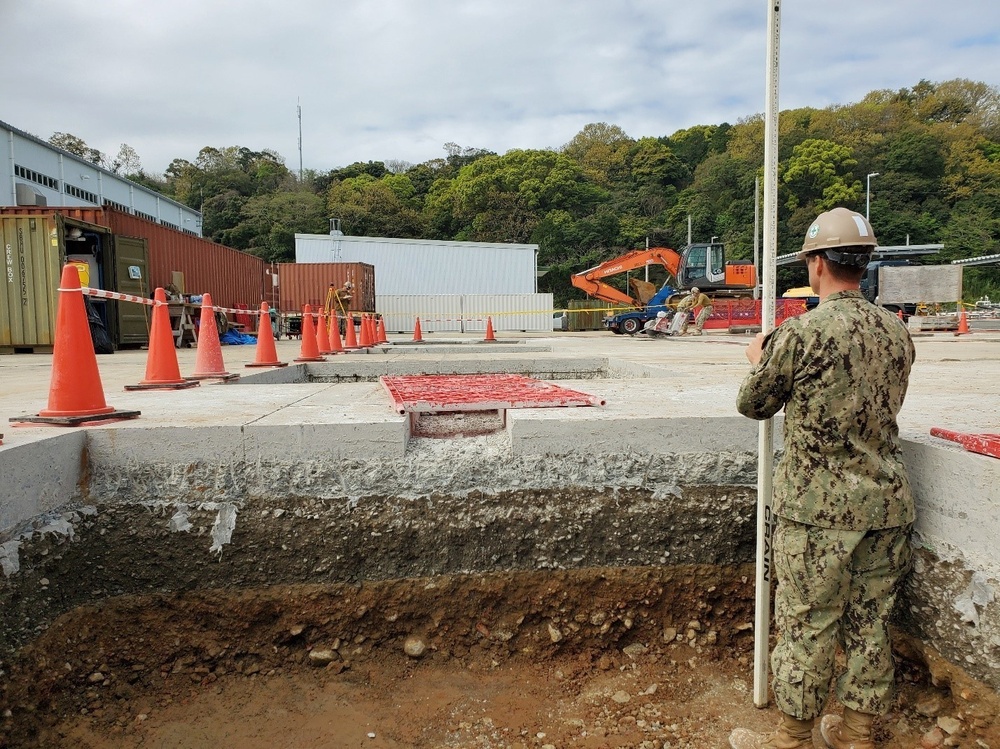 U.S. Navy Seabees with NMCB-5’s Detail Sasebo work on two pre-engineered buildings for NBU-7