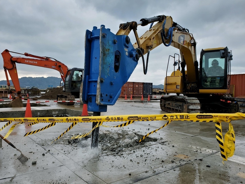 U.S. Navy Seabees with NMCB-5’s Detail Sasebo work on two pre-engineered buildings for NBU-7