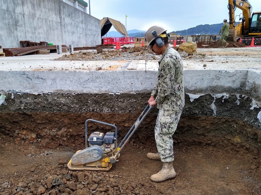 U.S. Navy Seabees with NMCB-5’s Detail Sasebo work on two pre-engineered buildings for NBU-7