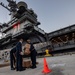 USS Theodore Roosevelt (CVN 71) move meals, ready to eat (MREs) for Sailors