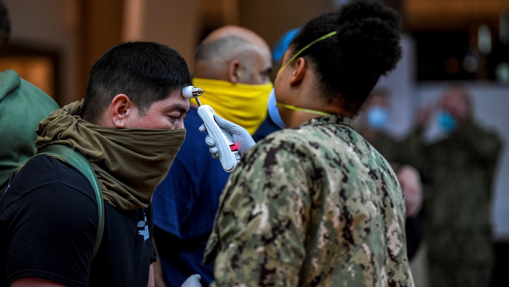 USS Theodore Roosevelt (CVN 71) move meals, ready to eat (MREs) for Sailors