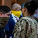 USS Theodore Roosevelt (CVN 71) move meals, ready to eat (MREs) for Sailors