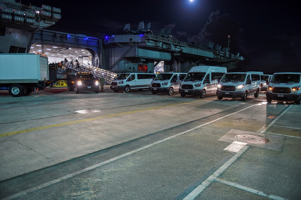 USS Theodore Roosevelt (CVN 71) move meals, ready to eat (MREs) for Sailors