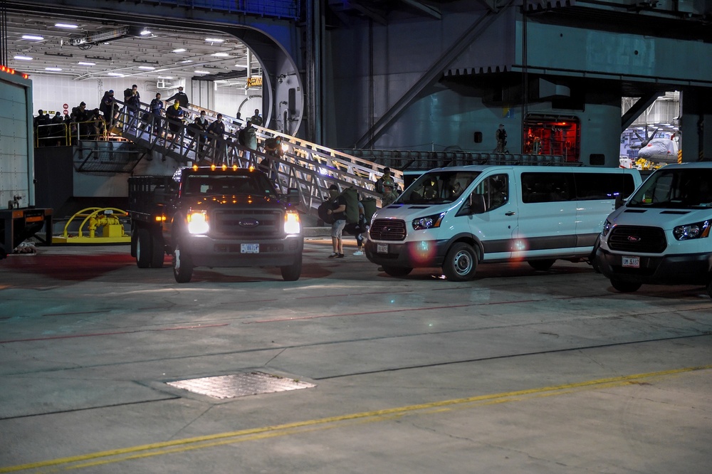 USS Theodore Roosevelt (CVN 71) move meals, ready to eat (MREs) for Sailors