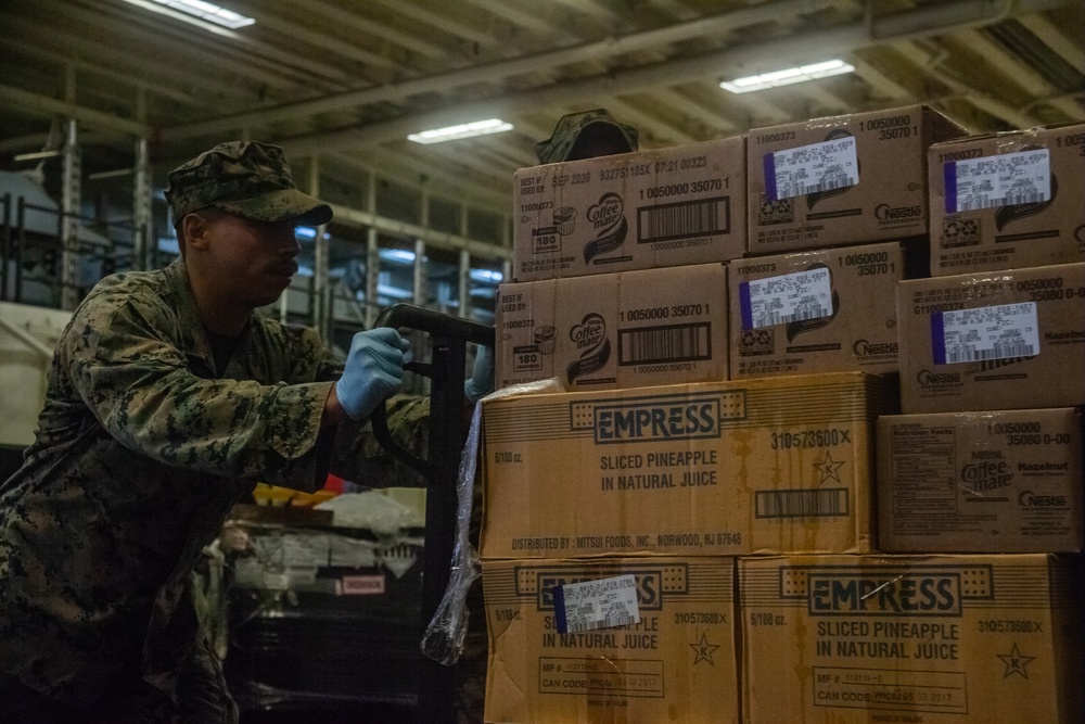 31st MEU Marines, USS America Sailors conduct supply onload at White Beach