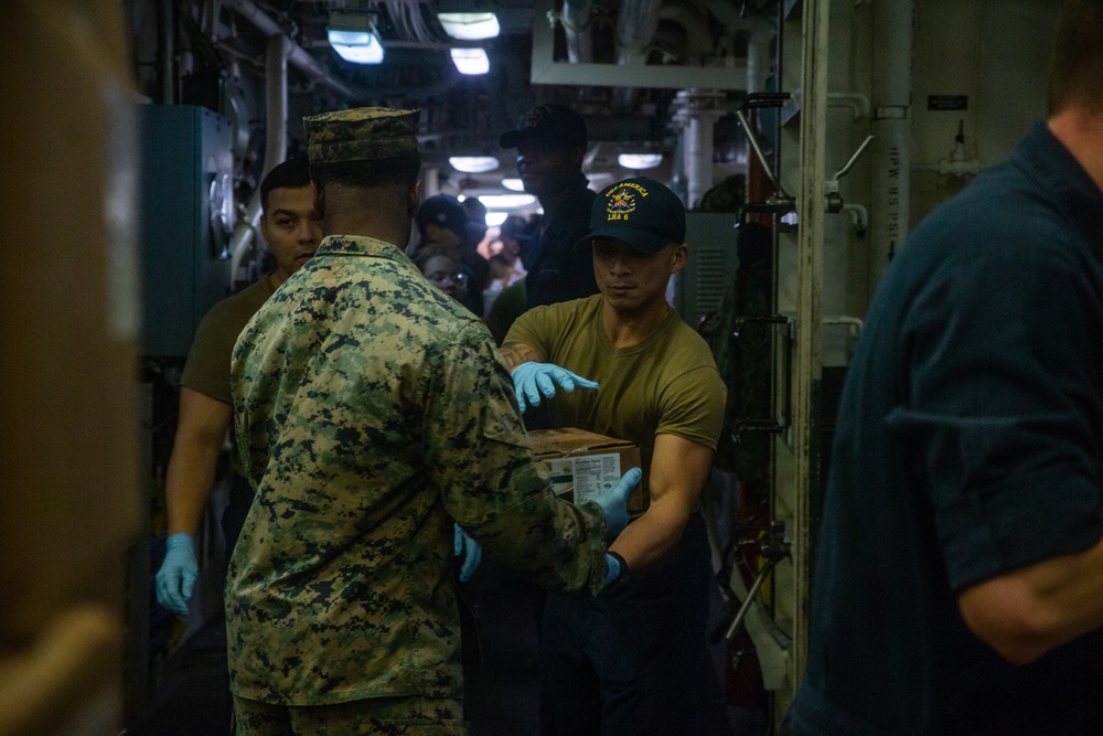 31st MEU Marines, USS America Sailors conduct supply onload at White Beach