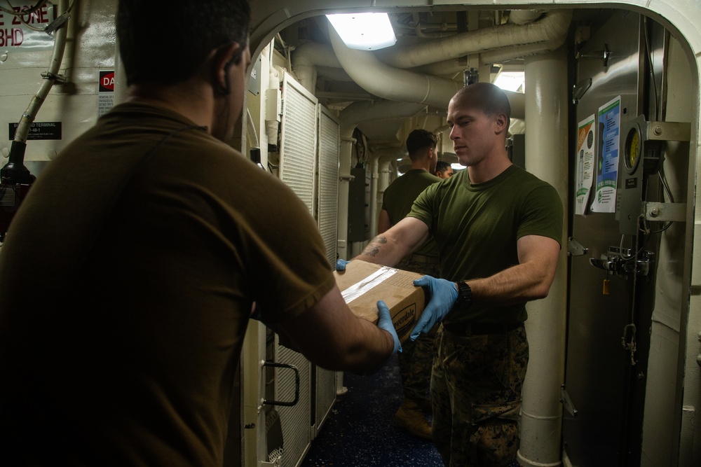 31st MEU Marines, USS America Sailors supply onload at White Beach