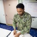 USNS Mercy Chief Prepares a Face Mask