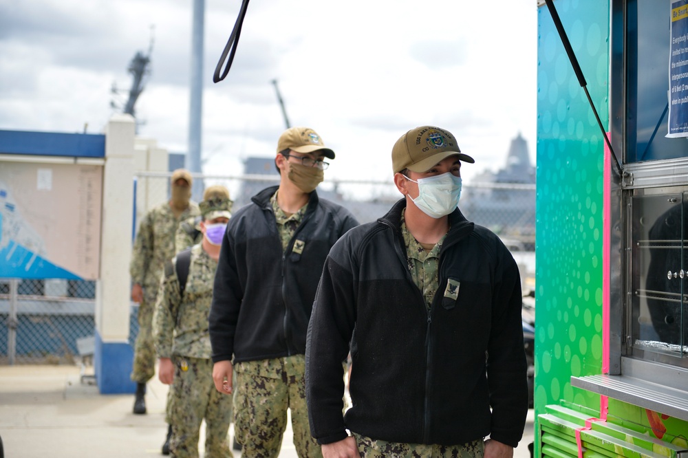 Sailors Wait in Line While Wearing Face Coverings