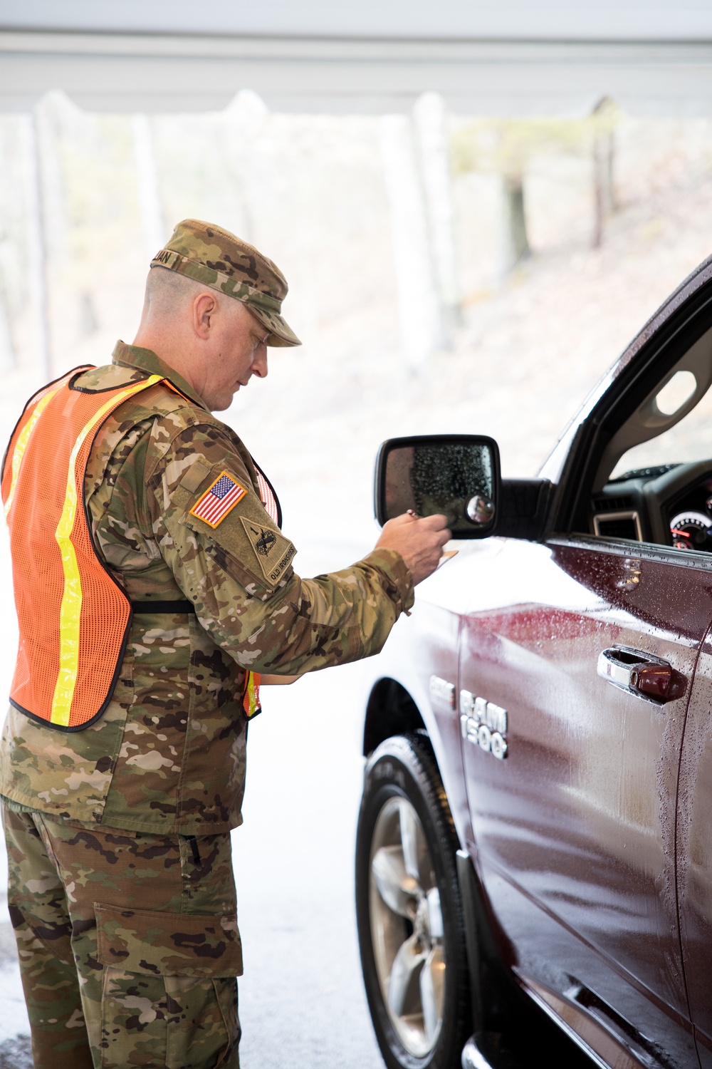 Teams of guardsmen conduct verbal and visual screenings of personnel entering bases across the Rhode Island National Guard