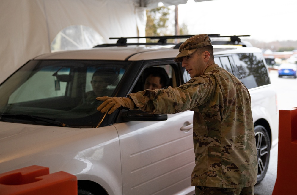 Teams of guardsmen conduct verbal and visual screenings of personnel entering bases across the Rhode Island National Guard
