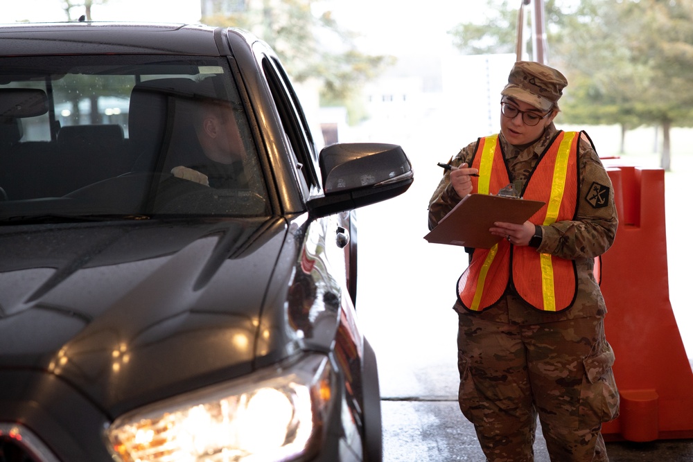 Teams of guardsmen conduct verbal and visual screenings of personnel entering bases across the Rhode Island National Guard