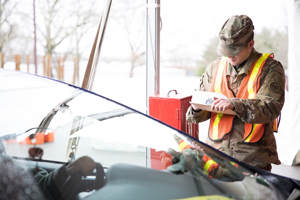 Teams of guardsmen conduct verbal and visual screenings of personnel entering bases across the Rhode Island National Guard
