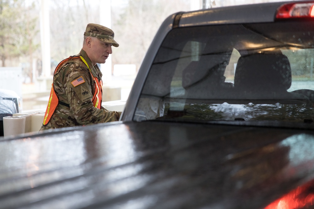 Teams of guardsmen conduct verbal and visual screenings of personnel entering bases across the Rhode Island National Guard