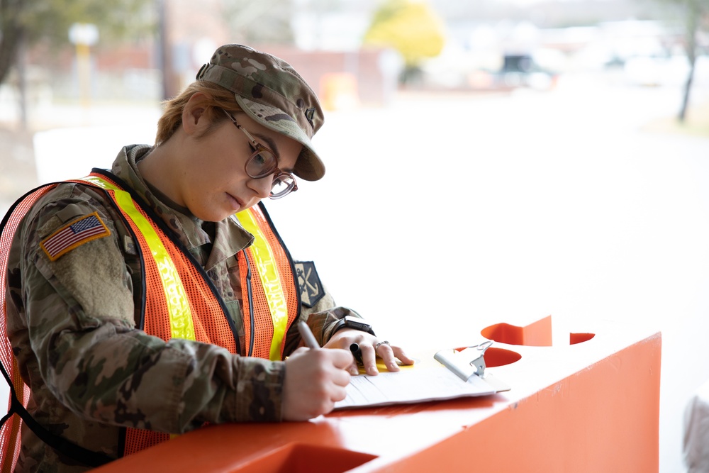 Teams of guardsmen conduct verbal and visual screenings of personnel entering bases across the Rhode Island National Guard