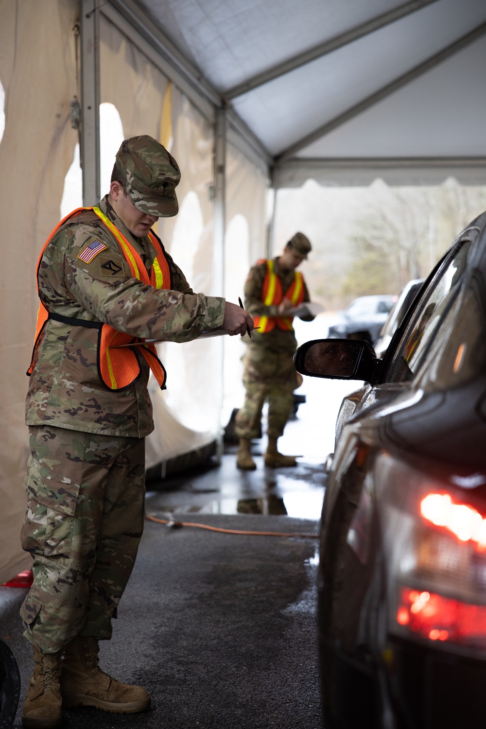 Teams of guardsmen conduct verbal and visual screenings of personnel entering bases across the Rhode Island National Guard