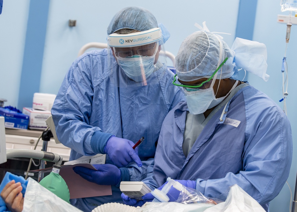 USNS Mercy Sailors Monitors Patient