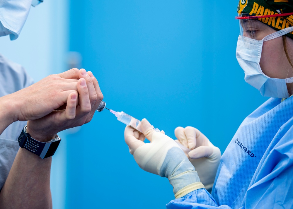 USNS Mercy Sailor Prepares a Syringe