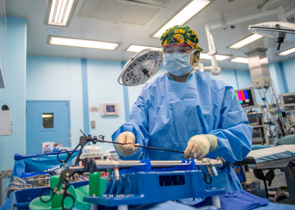 USNS Mercy Sailor Examines Tools