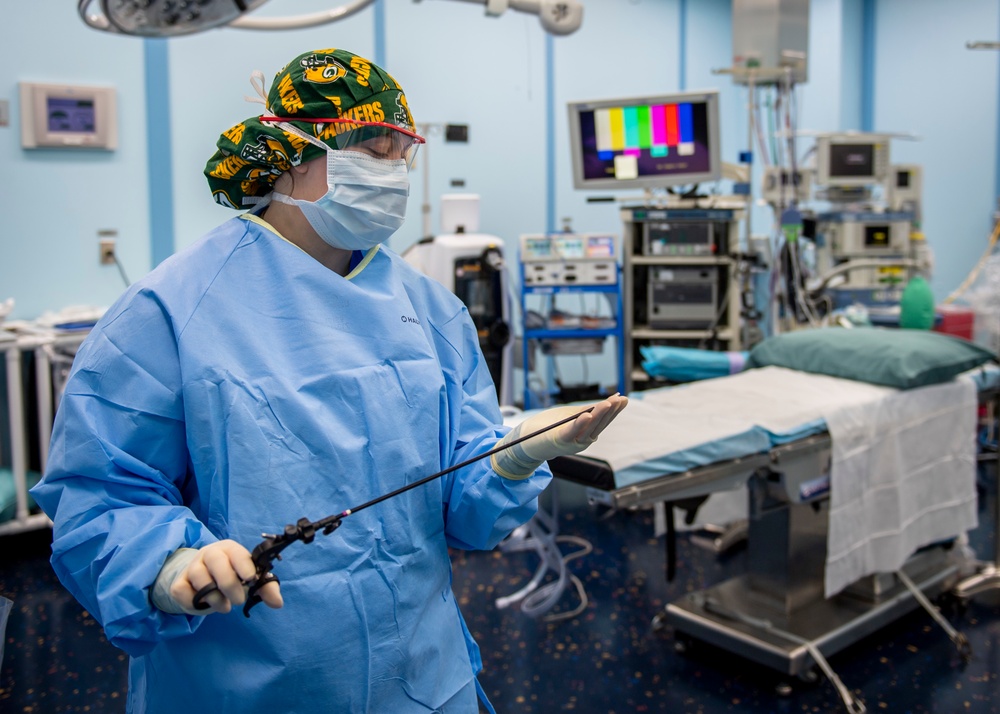 USNS Mercy Sailor Examines Tools