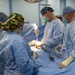 USNS Mercy Sailors Perform Surgery