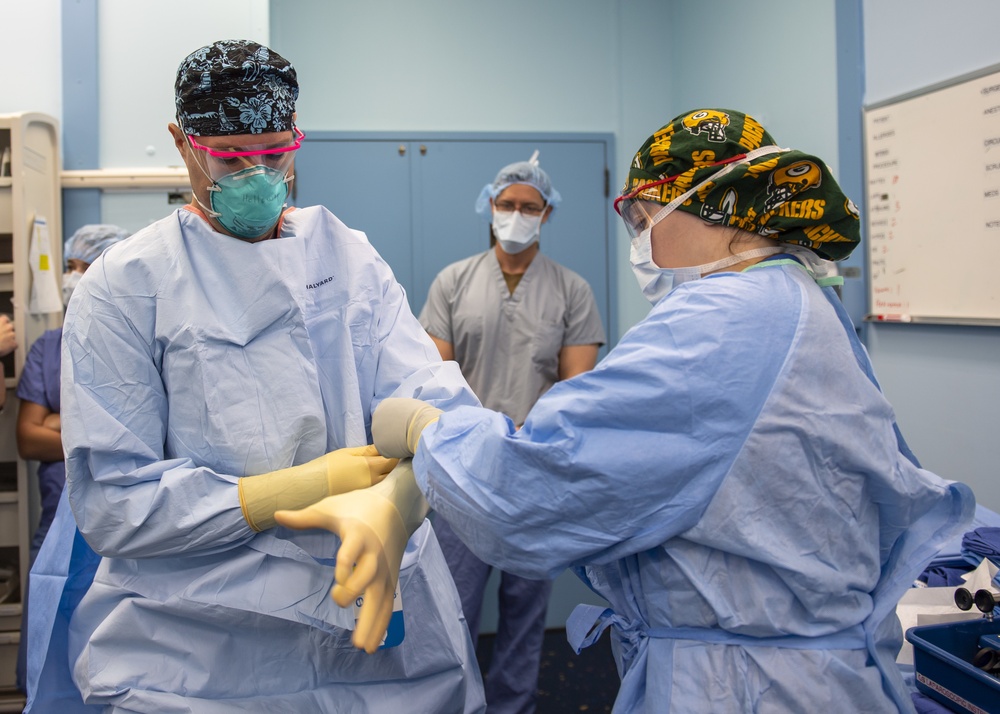 USNS Mercy Sailor Dons Surgical Gloves